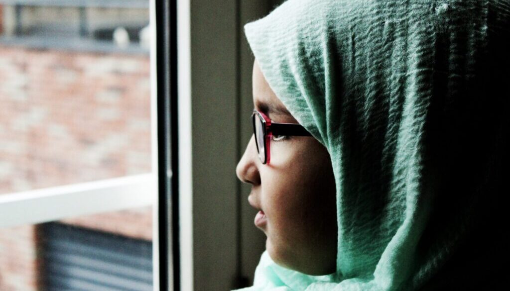 woman looking outside of the window during daytime