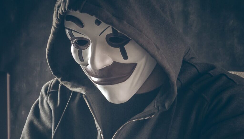 person in black hoodie wearing white mask