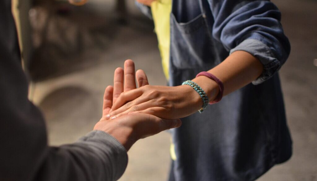 man and woman holding hands on street