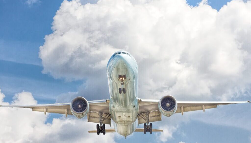gray and white airplane on flight near clear blue sky