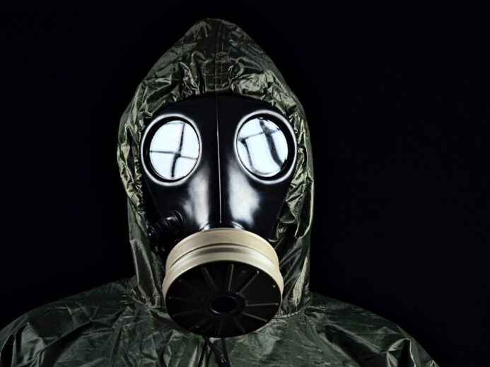 person in green and black gas mask