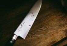 gray knife on brown wooden surface
