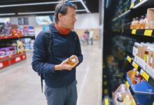 man standing beside display shelf