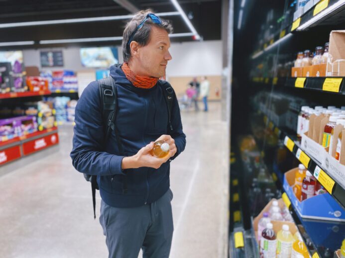 man standing beside display shelf
