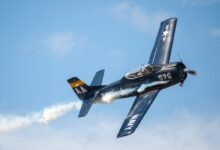 black biplane doing aerobatics