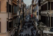 people in between two buildings at daytime