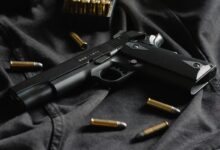 black semi automatic pistol on black textile