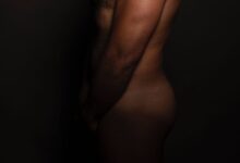 topless man with black background