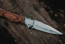 brown handle silver knife on brown wooden table