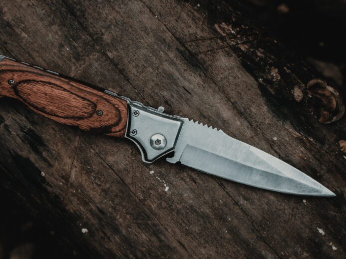 brown handle silver knife on brown wooden table