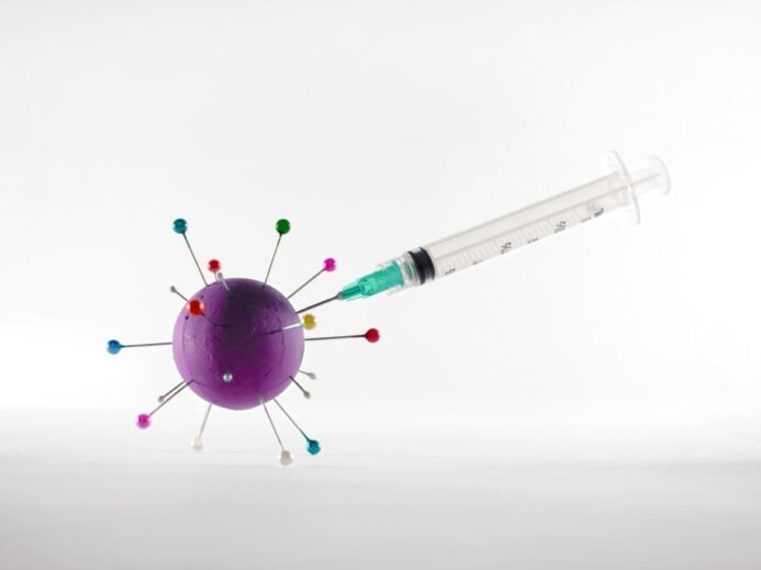 white and green syringe on white surface