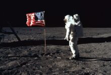 Buzz Aldrin on the moon in front of the US flag