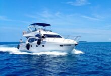 white and blue yacht on sea under blue sky during daytime