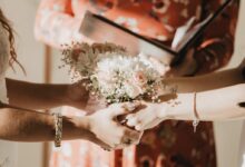 person holding white flower bouquet