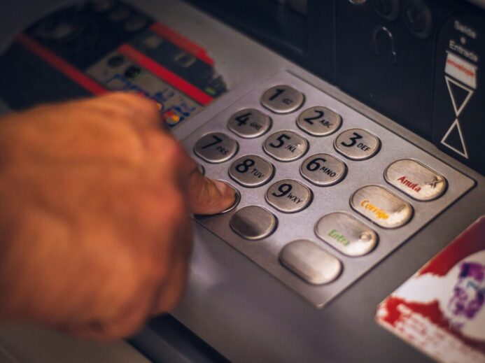 person holding white and red card