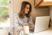 woman using her MacBook Pro inside white room