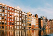 assorted-color buildings beside body of water
