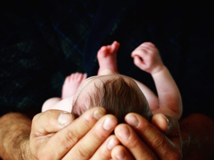 person holding babys hand