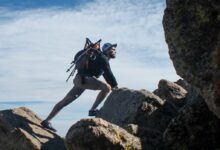 photo of man climbing mountain