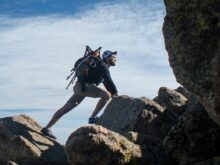photo of man climbing mountain