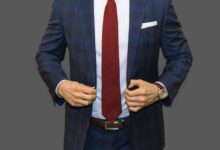 man in black suit jacket and red necktie