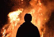 person standing in front of fire
