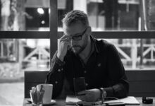 man in black jacket sitting at table