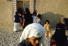 people standing near brown wooden door