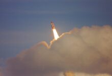low-angle photography of red space shuttle
