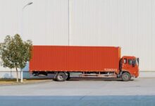 red freight truck beside building