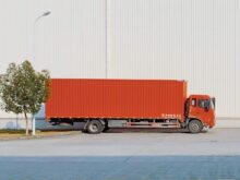 red freight truck beside building