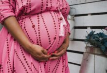 women's pink and red long-sleeved maternity dress