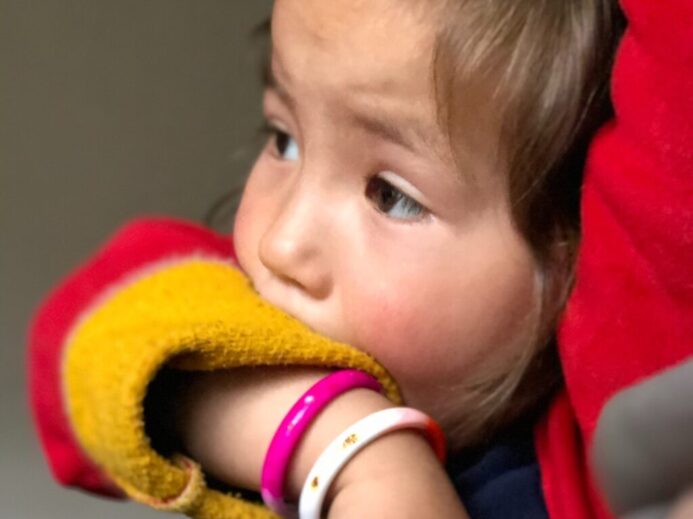 child in red and yellow knit cap
