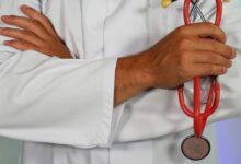 doctor holding red stethoscope