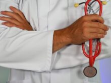 doctor holding red stethoscope
