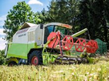 red and yellow heavy equipment on green grass field during daytime
