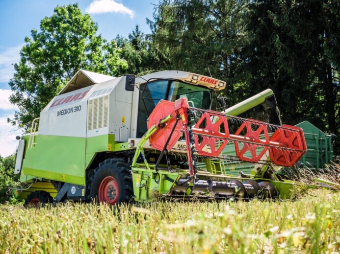 red and yellow heavy equipment on green grass field during daytime