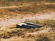 black revolver pistol on ground during daytime