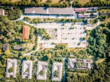 aerial photography of brown gray concrete buildings surrounded by trees