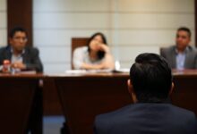 man in black shirt sitting beside woman in white shirt