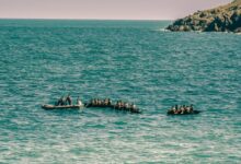people on boat on sea during daytime