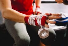 person wrapping bandage