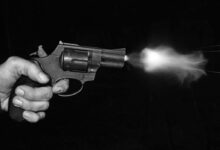 silver and black revolver on black surface