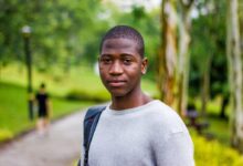 selective focus photography of man in gray crew-neck shirt