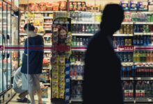man and woman standing in front of store