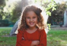 shallow focus photography of girl in red long-sleeved top