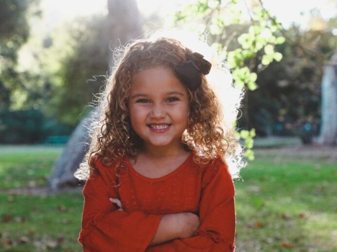 shallow focus photography of girl in red long-sleeved top