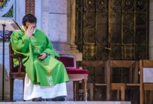 man in green robe sitting on chair