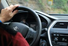 person sitting inside Suzuki vehicle