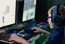 boy wearing headset playing computer game